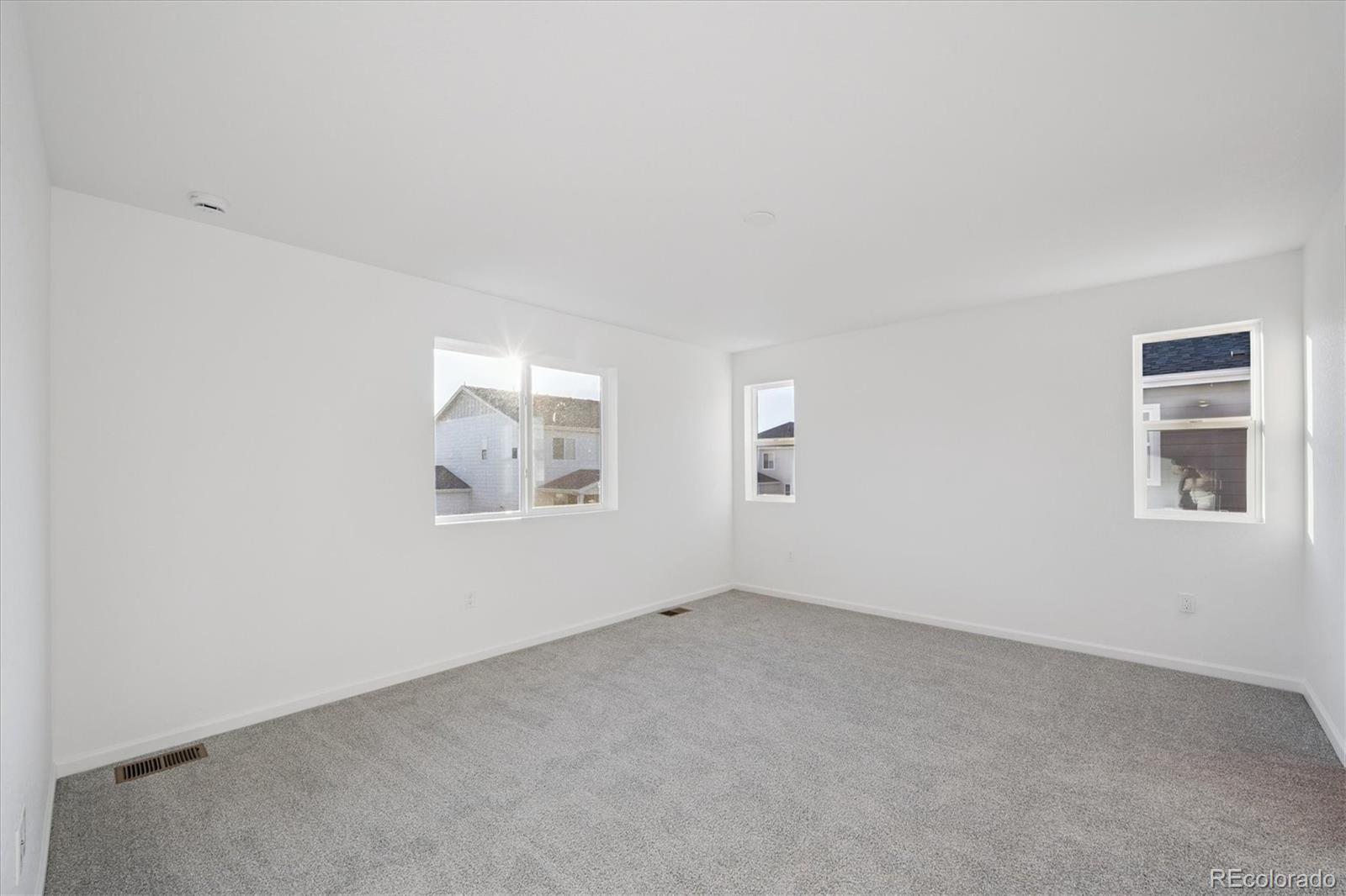 5594 Brangus Drive Windsor, CO 80528 - Photo 17 of 22 an empty room with windows