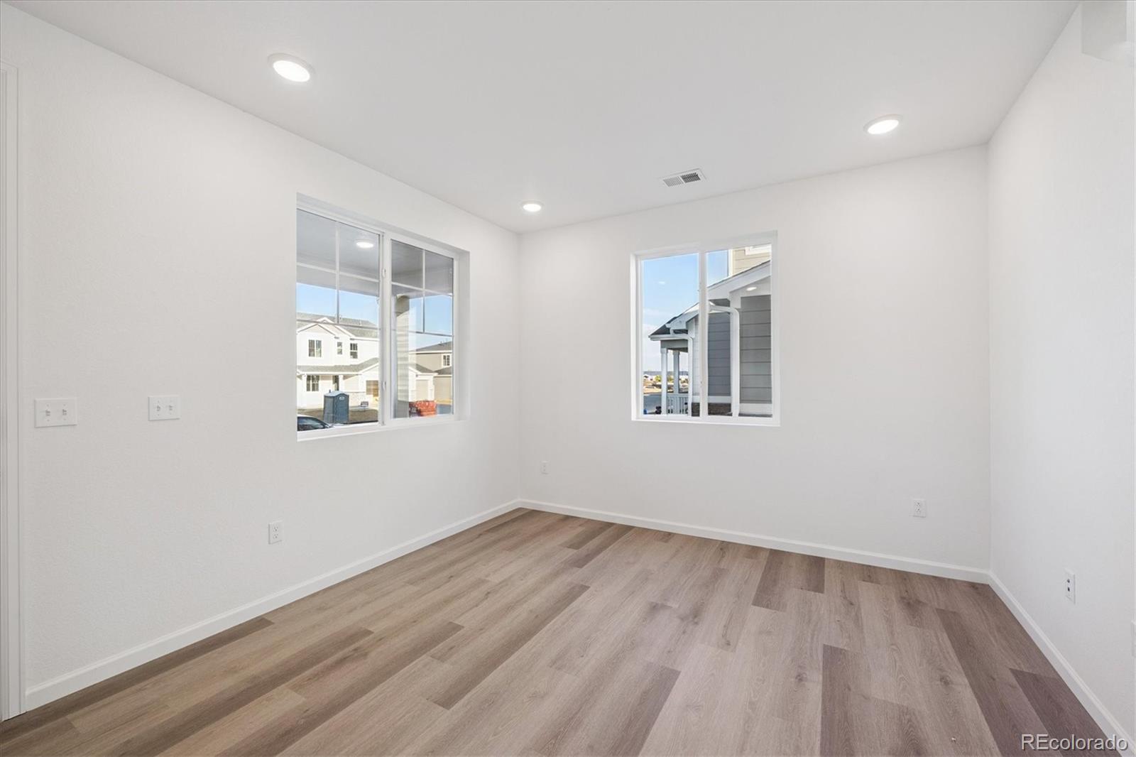 5594 Brangus Drive Windsor, CO 80528 - Photo 3 of 22 a view of empty room with wooden floor and fan