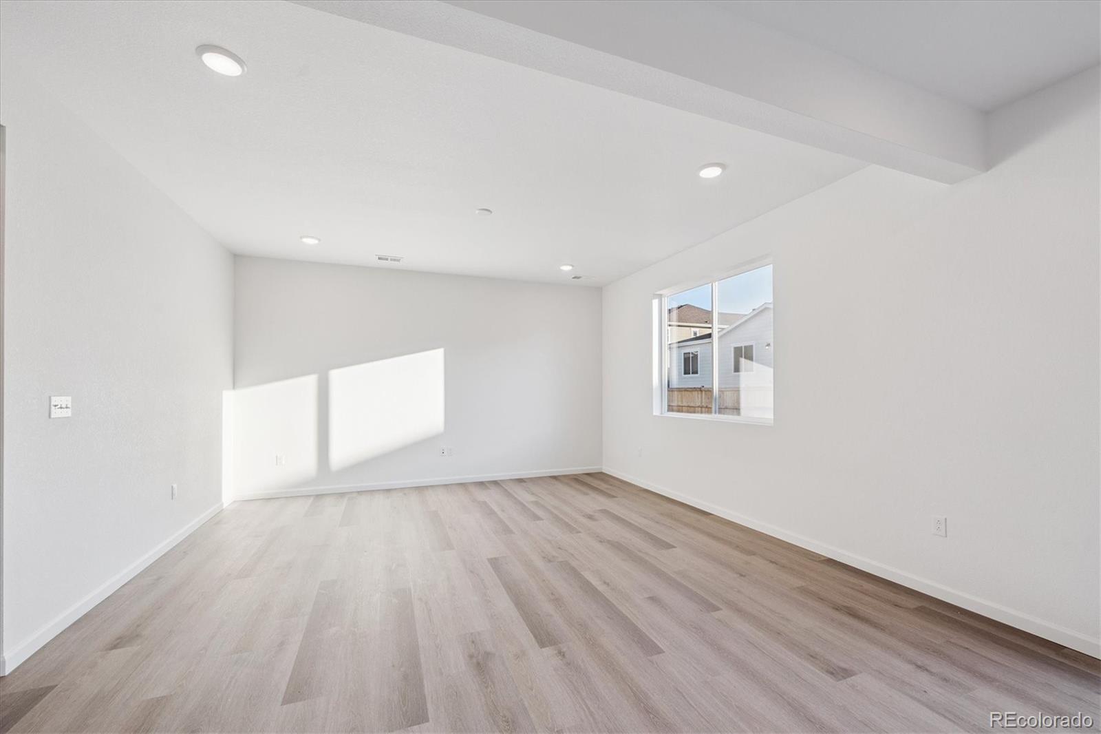 5594 Brangus Drive Windsor, CO 80528 - Photo 6 of 22 wooden floor in an empty room with a window