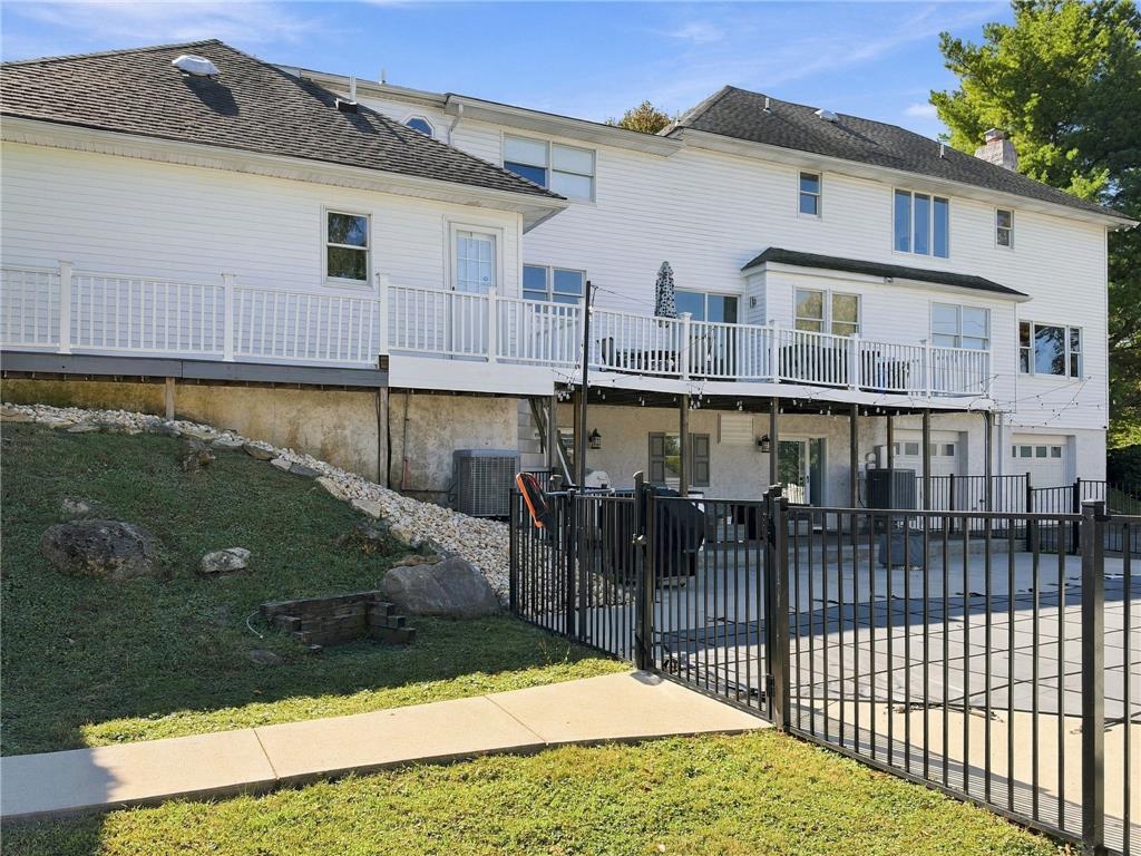 755 Yorkshire Road Allentown, PA 18103 - Photo 65 of 66 An elevated wood deck with white railings overlooks a fenced pool area.