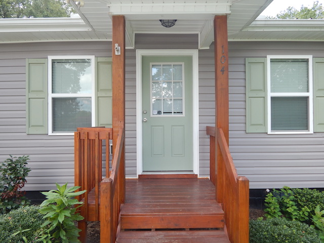 104 Leah Drive Pendleton, SC 29670 - Photo 2 of 17 The welcoming entryway features a wooden porch, leading to a front door with elegant window details.