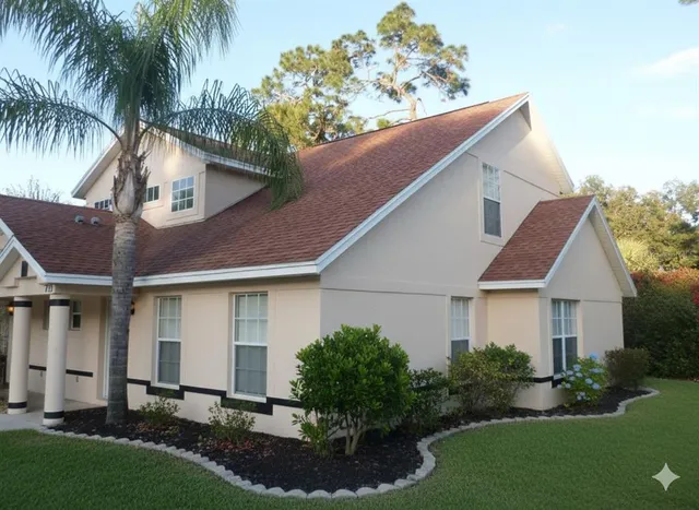 a aerial view of a house with a yard and potted plants
