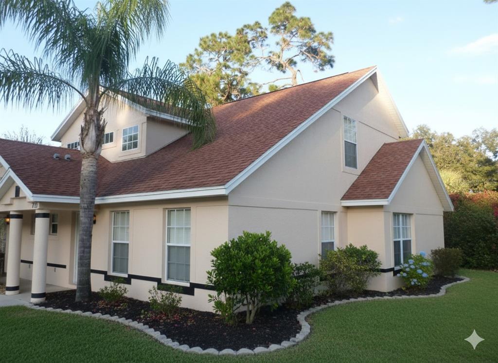 a aerial view of a house with a yard and potted plants