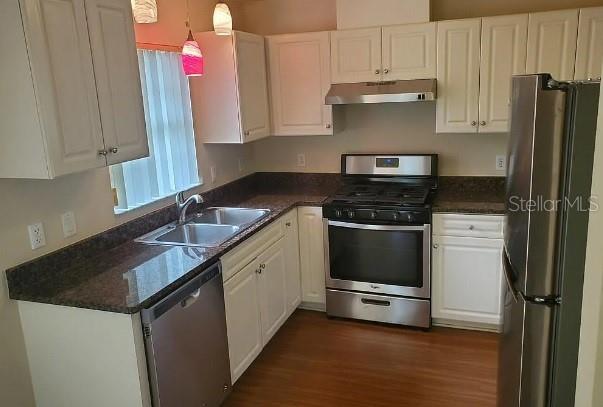 815 East Rembrandt Way, Unit 424 Inverness, FL 34453 - Photo 2 of 4 a kitchen with granite countertop a sink stainless steel appliances and cabinets