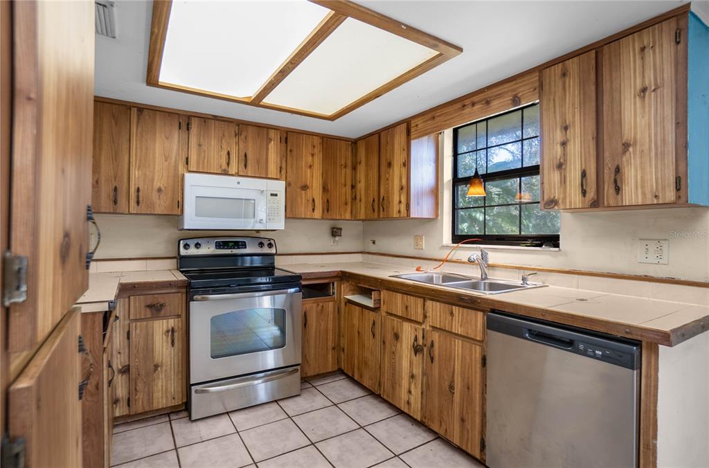 4893 South Old Floral City Road Inverness, FL 34450 - Photo 11 of 31 a kitchen with a sink stove and cabinets