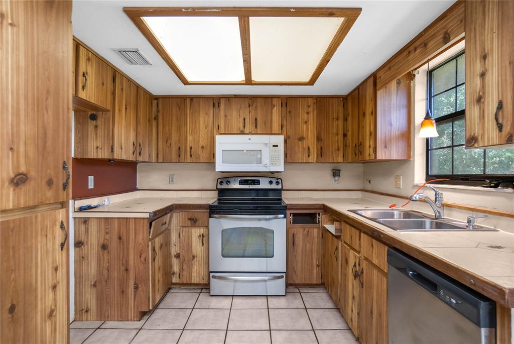 4893 South Old Floral City Road Inverness, FL 34450 - Photo 12 of 31 a kitchen with a stove sink and cabinets