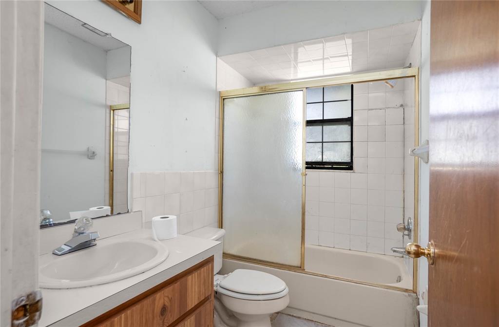 4893 South Old Floral City Road Inverness, FL 34450 - Photo 21 of 31 a bathroom with a sink a toilet and shower