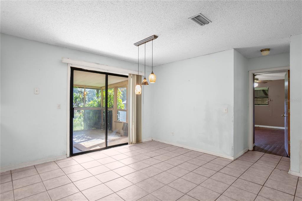 4893 South Old Floral City Road Inverness, FL 34450 - Photo 10 of 31 a view of an empty room with window and chandelier