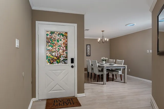 a view of a dining room with furniture and chandelier