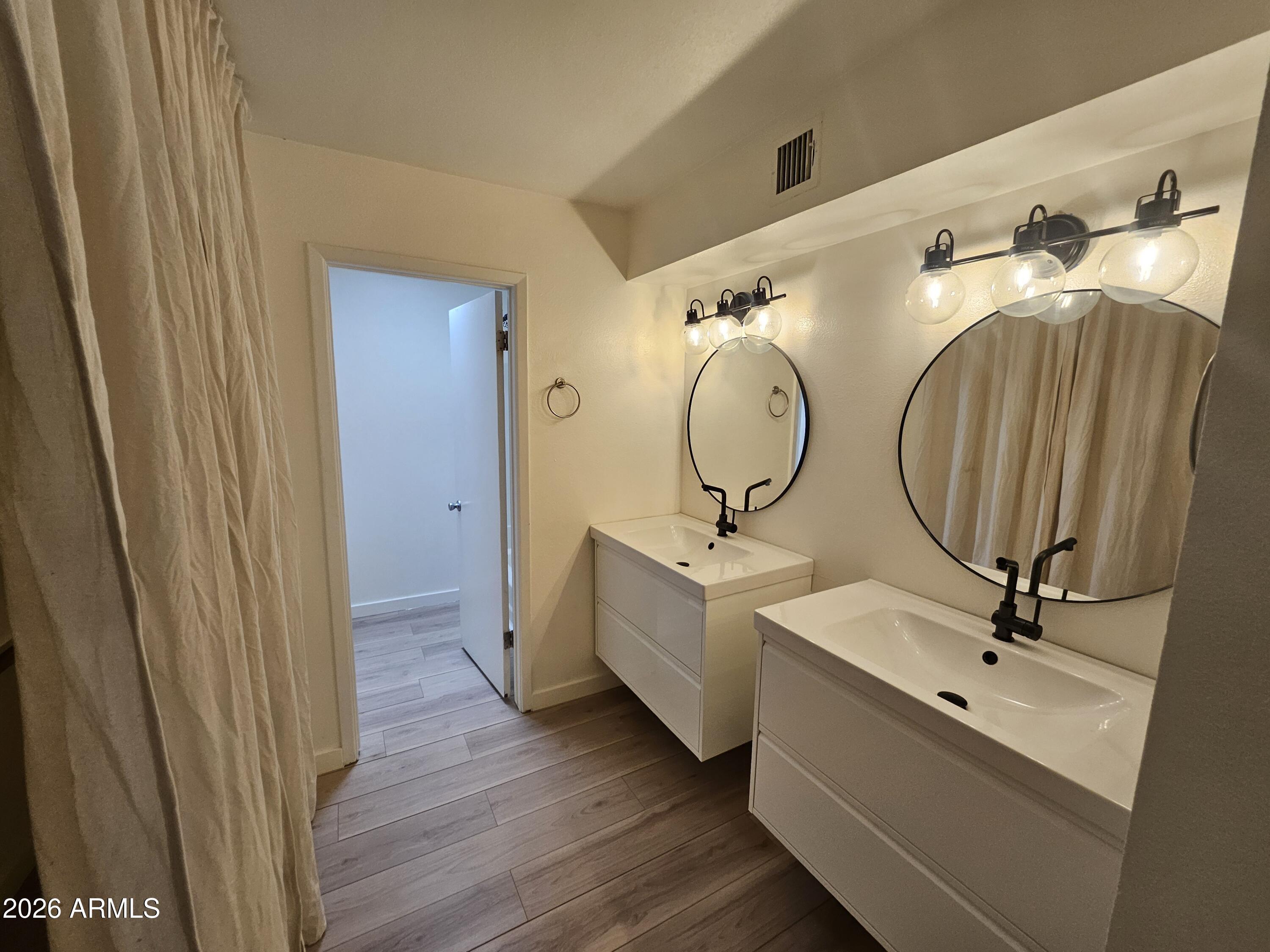 7038 South 42nd Street Phoenix, AZ 85042 - Photo 18 of 22 a bathroom with 2 sink and mirror