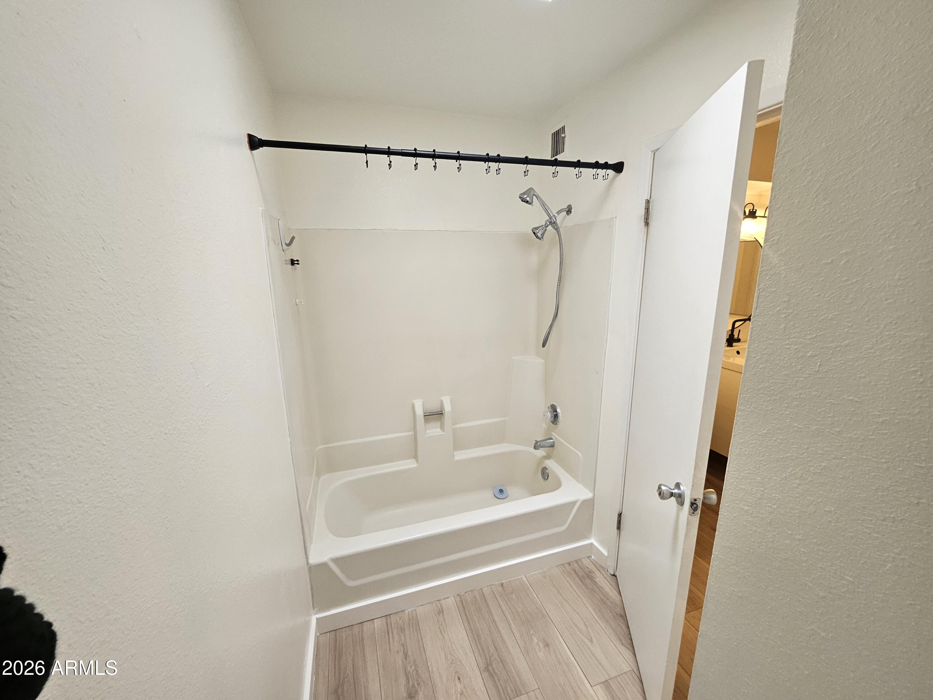 7038 South 42nd Street Phoenix, AZ 85042 - Photo 19 of 22 a bathroom with a bathtub and a shower