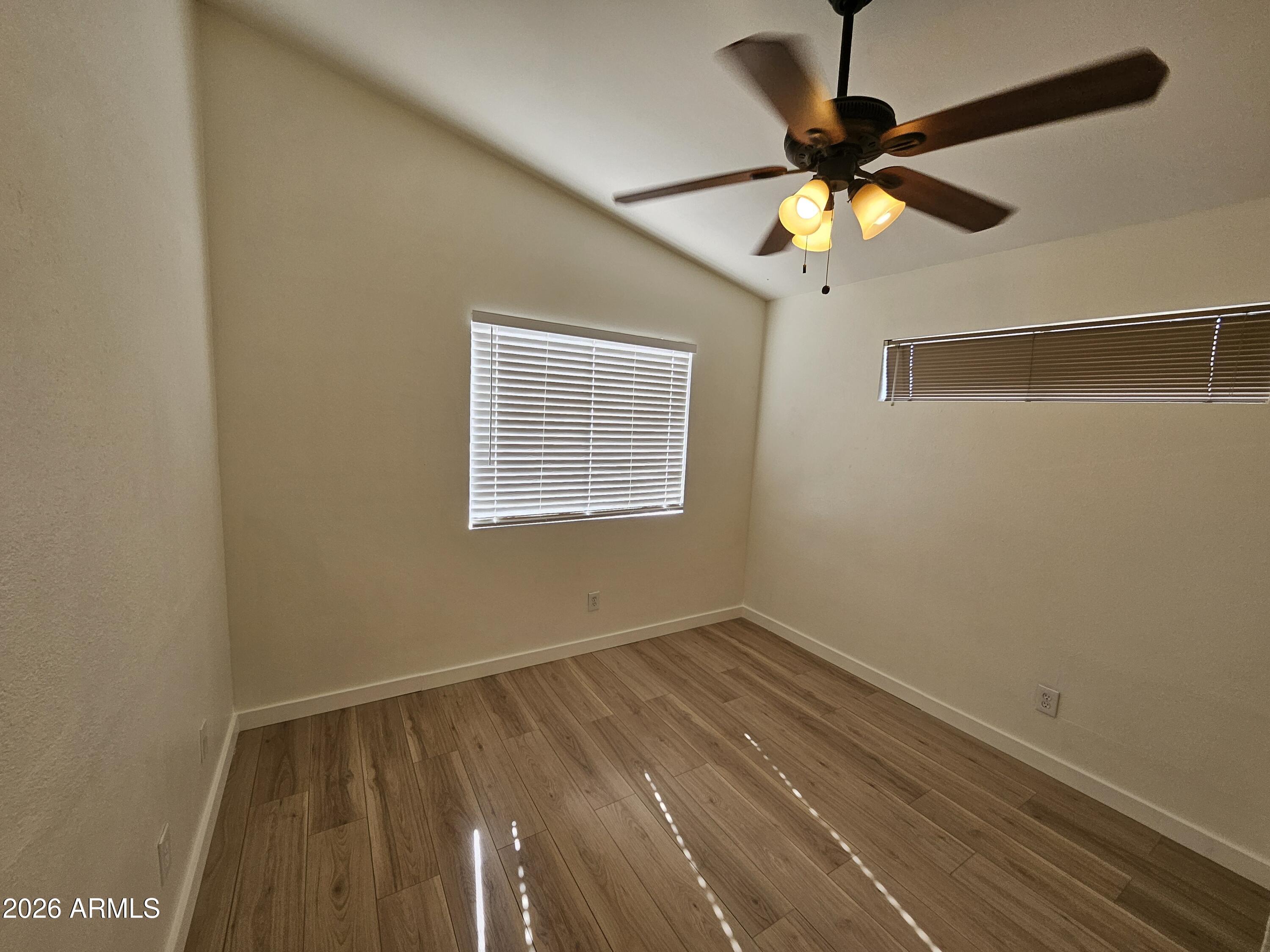 7038 South 42nd Street Phoenix, AZ 85042 - Photo 20 of 22 a view of room with a ceiling fan and a fan