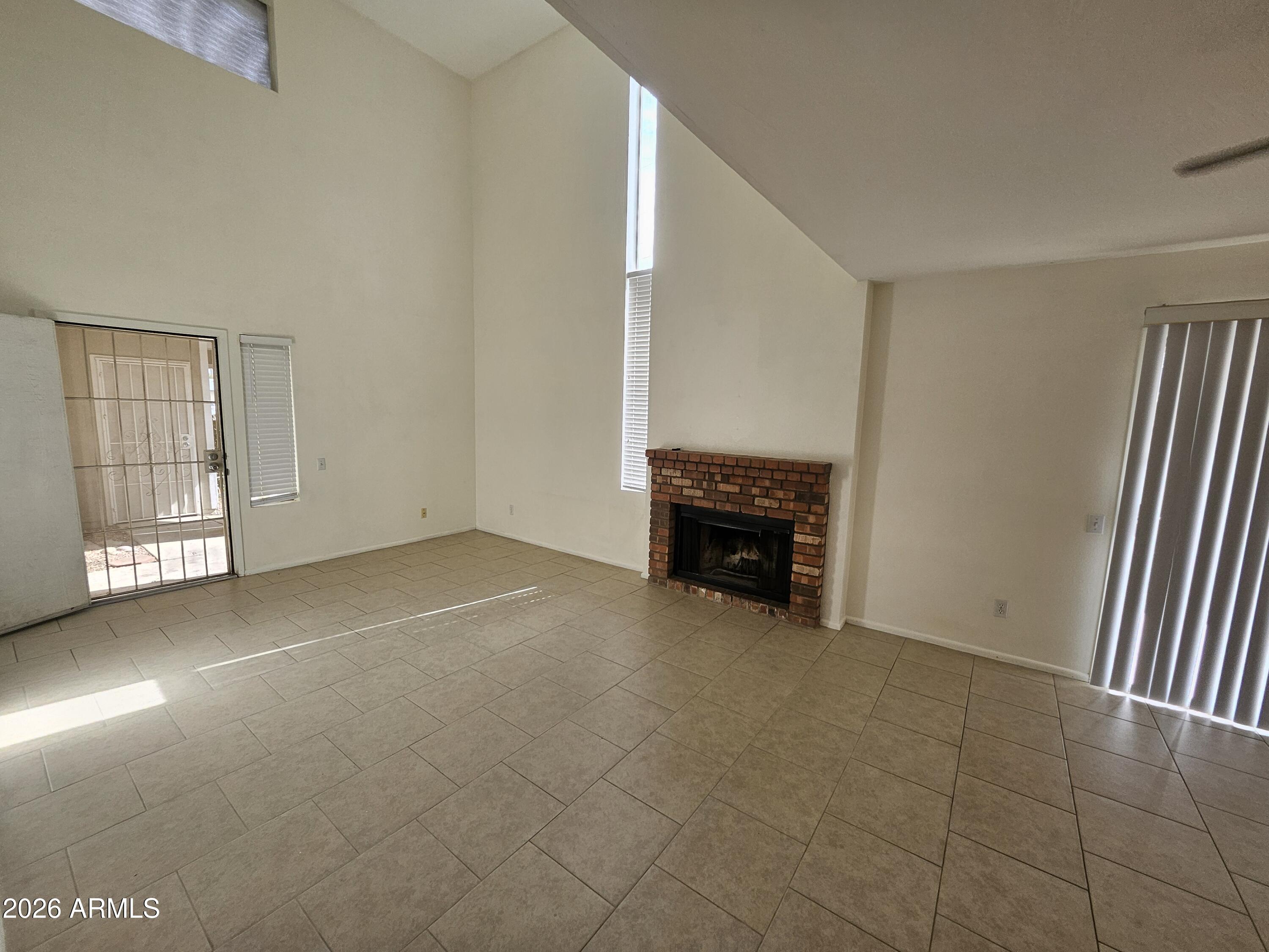 7038 South 42nd Street Phoenix, AZ 85042 - Photo 6 of 22 an empty room with windows