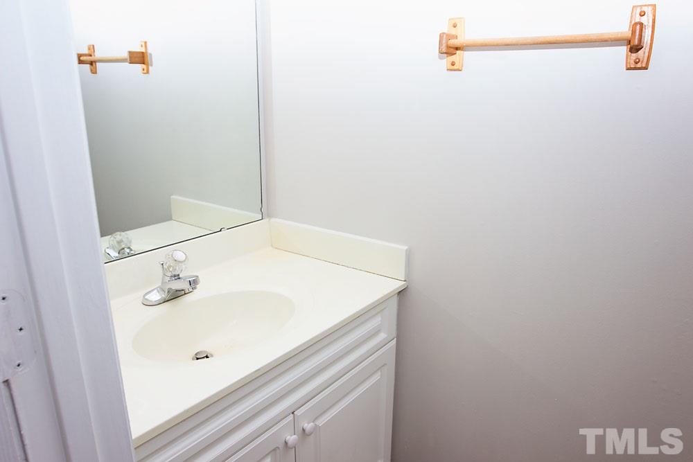 4308 Windstorm Way Raleigh, NC 27616 - Photo 11 of 16 a bathroom with a sink and a mirror