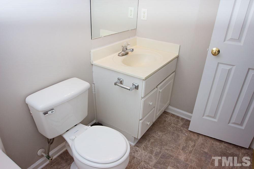 4308 Windstorm Way Raleigh, NC 27616 - Photo 13 of 16 a white toilet sitting next to a bathroom sink