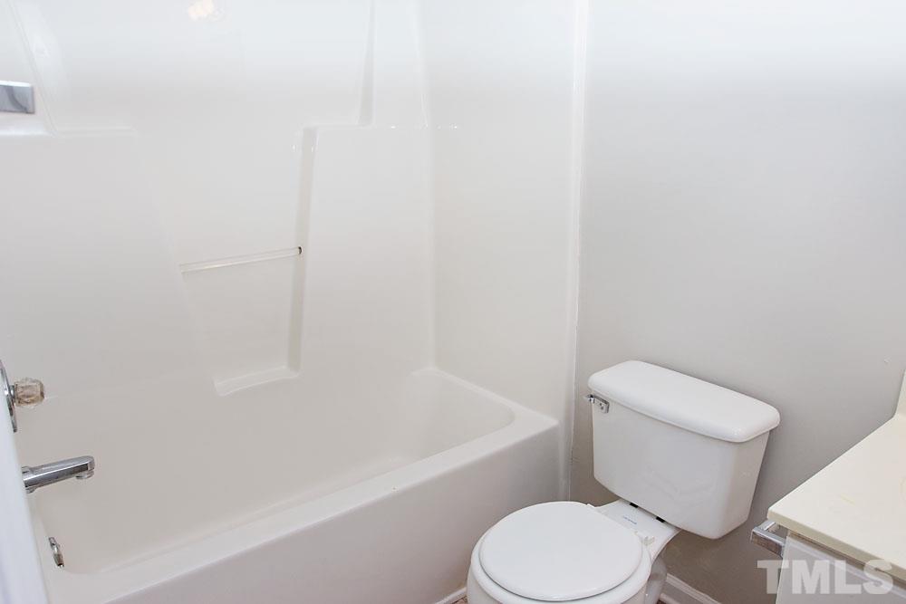 4308 Windstorm Way Raleigh, NC 27616 - Photo 16 of 16 a white toilet and a bath tub