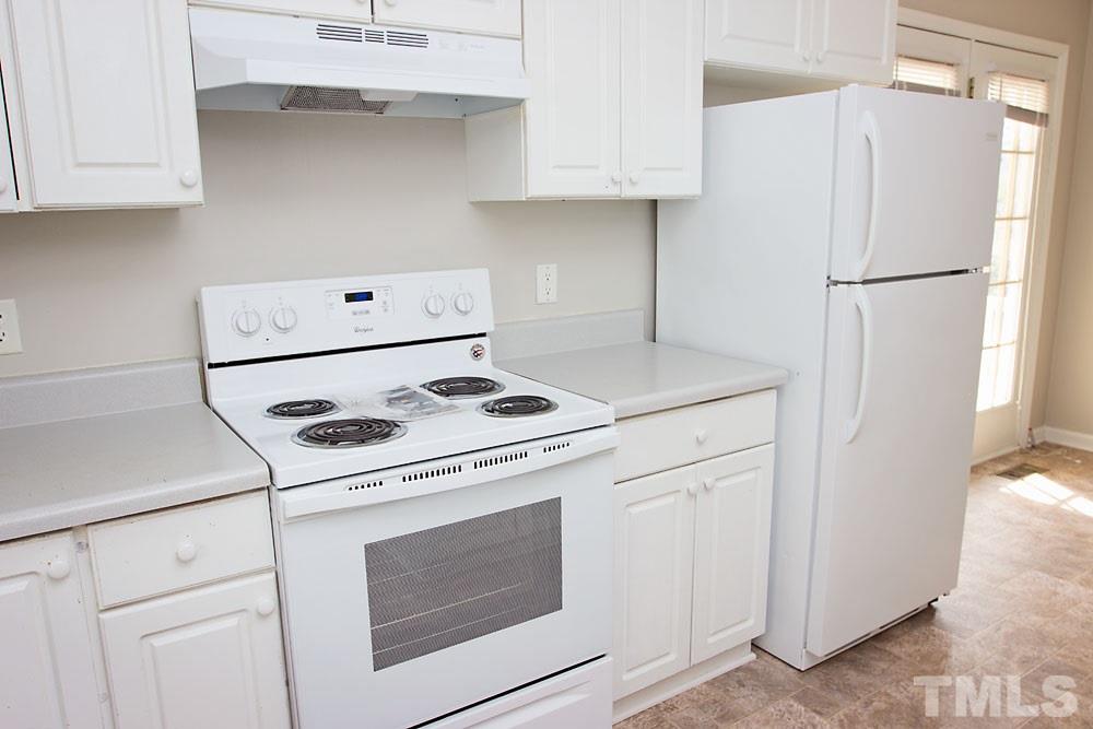 4308 Windstorm Way Raleigh, NC 27616 - Photo 9 of 16 a kitchen with a stove and a refrigerator
