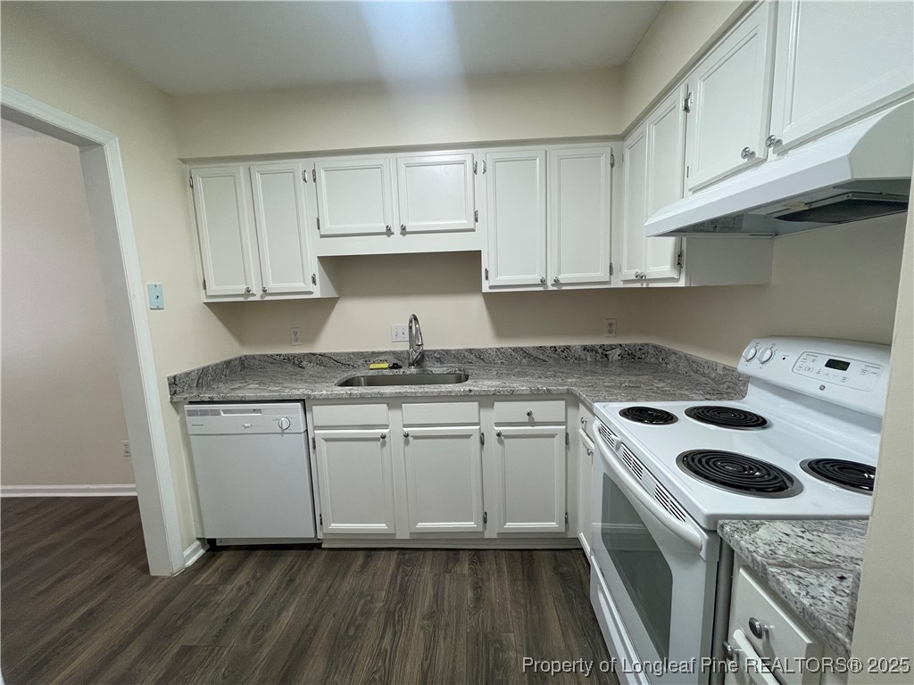 2059 Trexler Court Raleigh, NC 27606 - Photo 5 of 16 a kitchen with granite countertop a sink a stove and cabinets