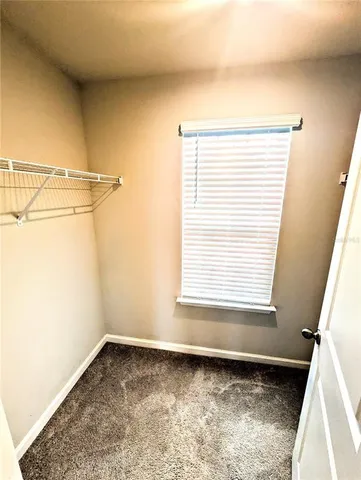 a white toilet sitting next to a white cabinet