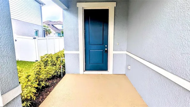 a view of a kitchen with kitchen island stainless steel appliances a sink cabinets and a window