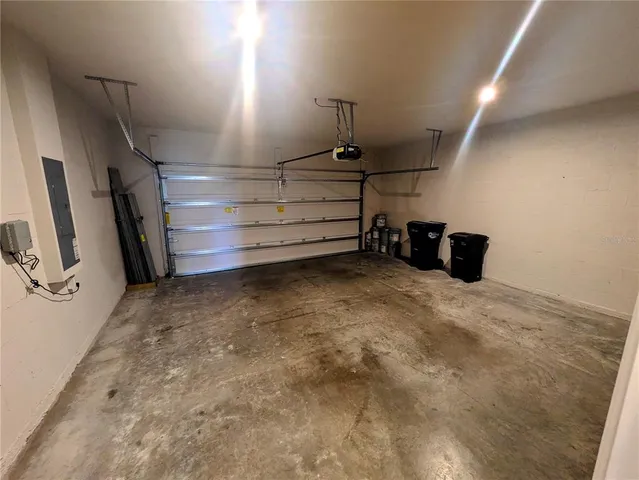 a view of house with garden and a tree