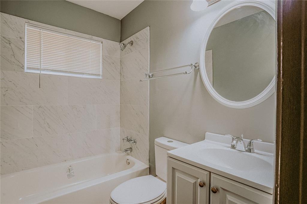 2877 Whispering Hills Drive, Unit 2877 Atlanta, GA 30341 - Photo 7 of 17 a bathroom with a sink toilet and shower
