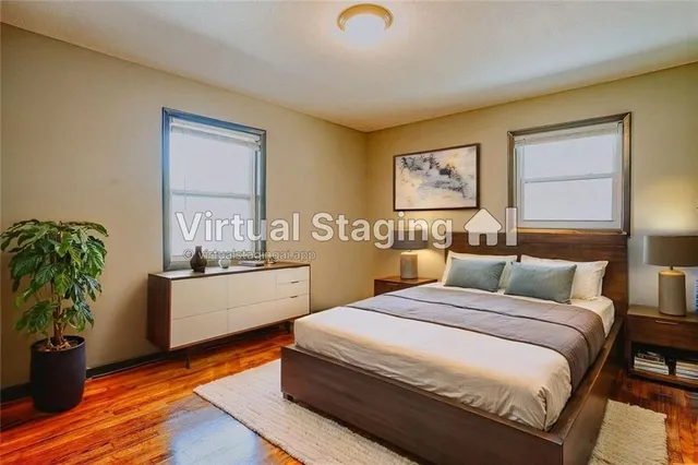 a bedroom with a bed and a potted plant