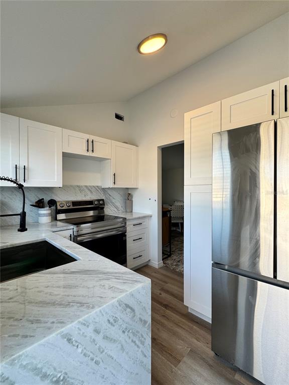 6980 Poinsetta Avenue Longboat Key, FL 34228 - Photo 11 of 18 a kitchen with a refrigerator and a sink