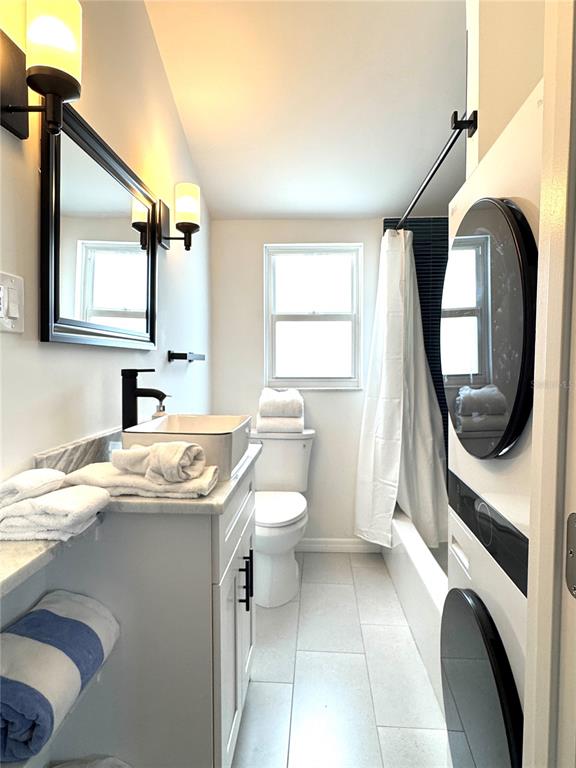 6980 Poinsetta Avenue Longboat Key, FL 34228 - Photo 14 of 18 a bathroom with a granite countertop toilet sink and mirror