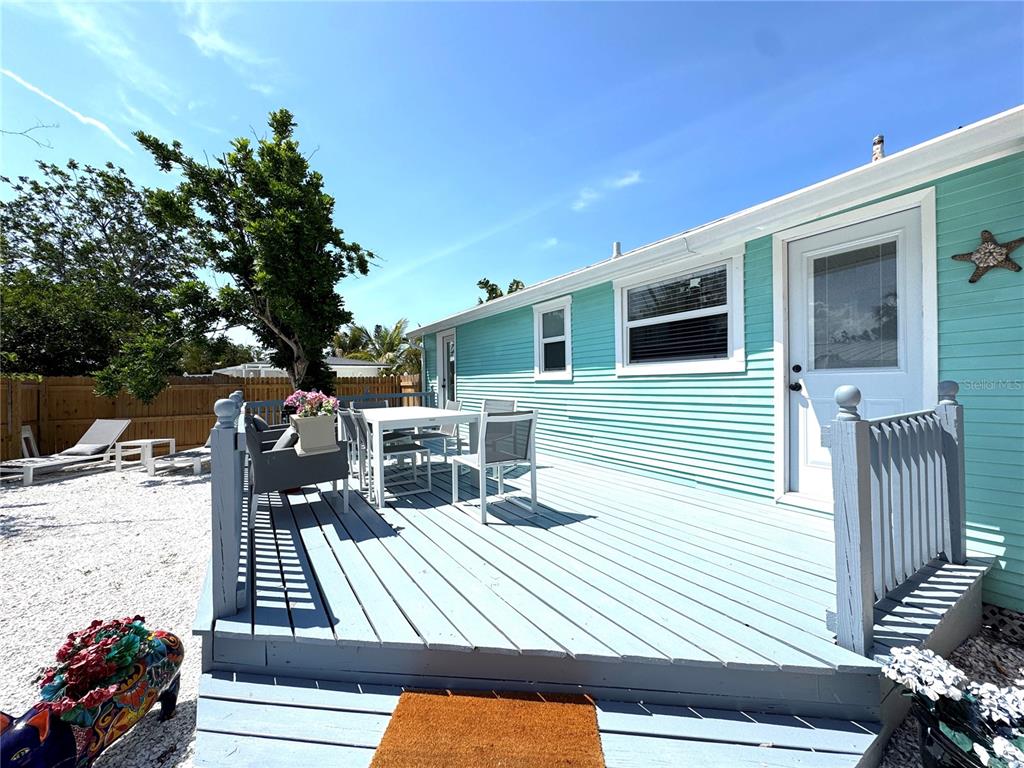 6980 Poinsetta Avenue Longboat Key, FL 34228 - Photo 17 of 18 a view of a deck with wooden floor and seating space