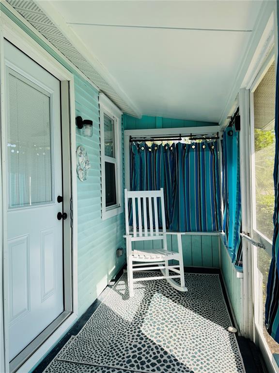 6980 Poinsetta Avenue Longboat Key, FL 34228 - Photo 3 of 18 a bedroom with a chair and a window
