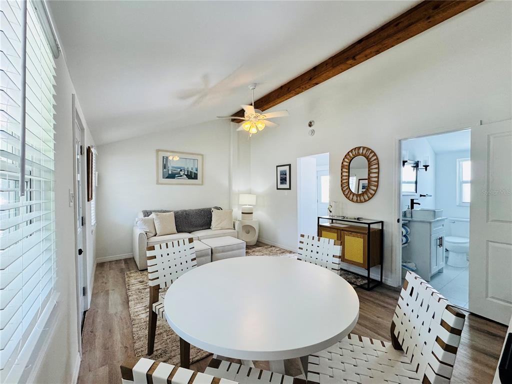 6980 Poinsetta Avenue Longboat Key, FL 34228 - Photo 9 of 18 a living room with furniture a mirror and a fireplace
