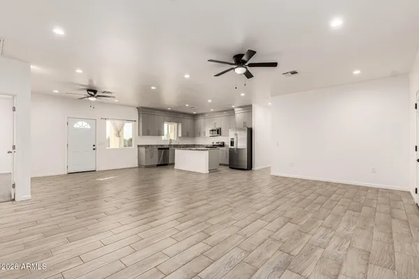 a kitchen with a refrigerator sink and cabinets