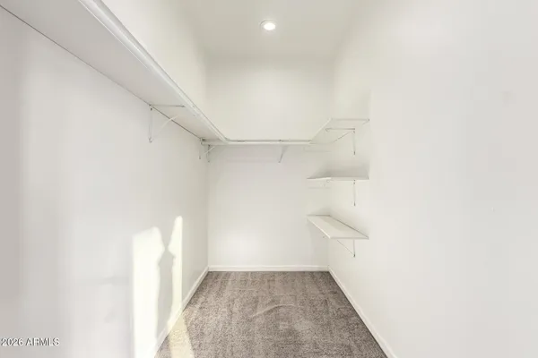 an empty room with a window and a ceiling fan