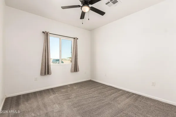 an empty room with view of ceiling fan