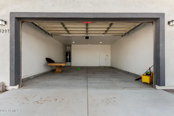 a view of an empty room with wooden fence