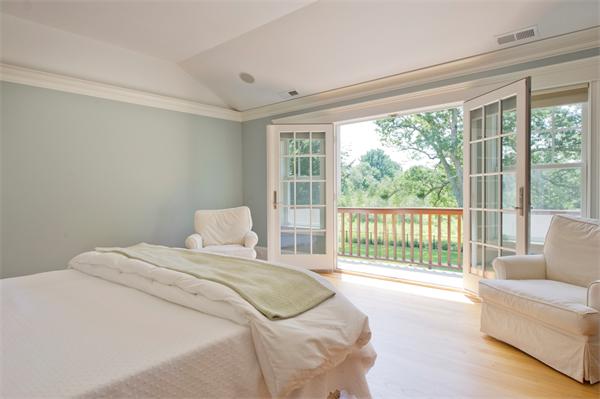 60 Sunset Road Weston, MA 02493 - Photo 13 of 17 a bedroom with a bed and a large window