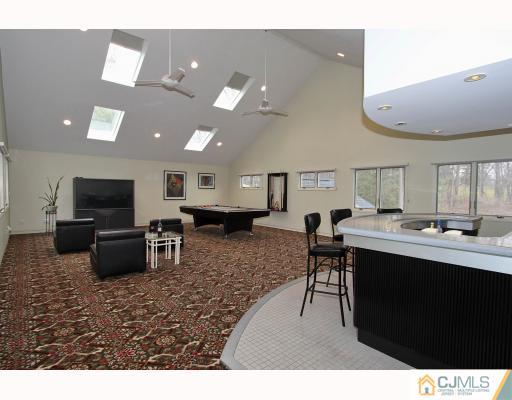 2 Wendover Road Edison, NJ 08820 - Photo 9 of 10 a living room with furniture a flat screen tv and kitchen view