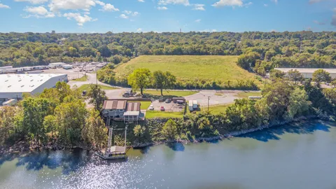 an aerial view of residential building and lake