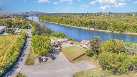 an aerial view of a houses with a lake view