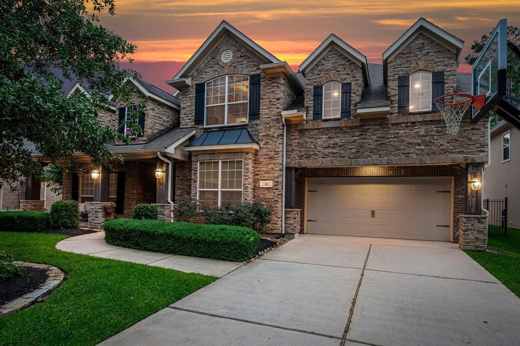 Located in the highly desirable Tupelo Green neighborhood of Creekside Park, this gorgeous 5 bedroom home has beautiful curb appeal with stacked stone exterior and enhanced landscaping.