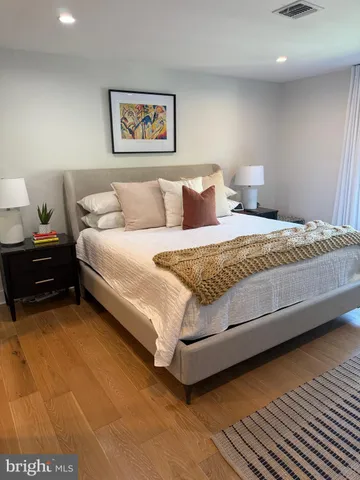 a spacious bedroom with a bed and a couch