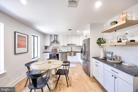 a kitchen with stainless steel appliances kitchen island granite countertop a sink and cabinets