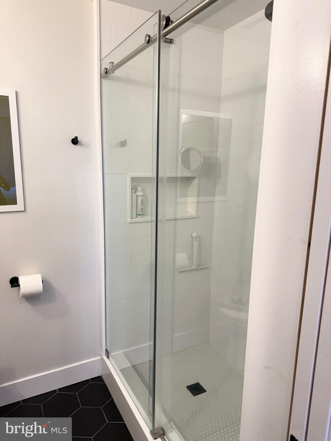 411 Conestoga Road, Unit 22 Devon, PA 19333 - Photo 9 of 14 a bathroom with a glass shower door