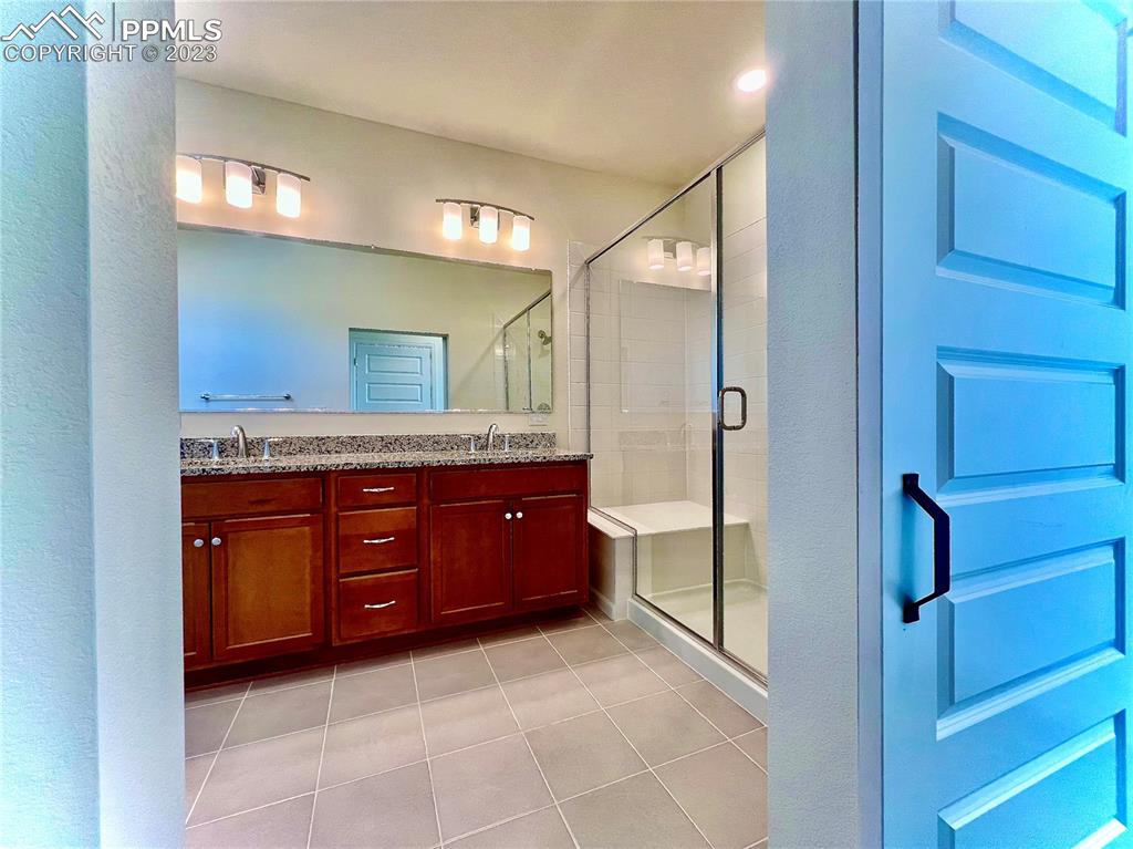 3865 Presidio Point, Unit 202 Colorado Springs, CO 80920 - Photo 11 of 30 a spacious bathroom with a granite countertop sink and a mirror