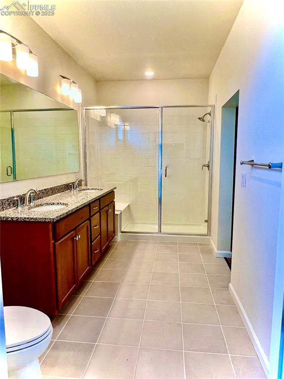 3865 Presidio Point, Unit 202 Colorado Springs, CO 80920 - Photo 15 of 30 a bathroom with a granite countertop sink toilet and shower