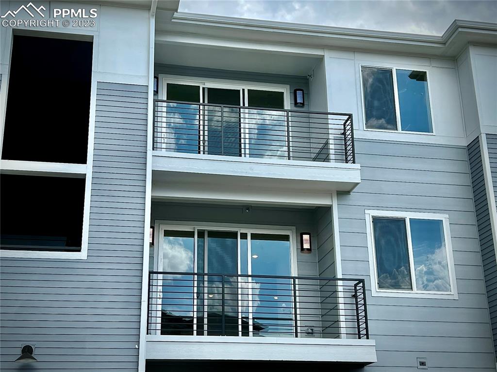 3865 Presidio Point, Unit 202 Colorado Springs, CO 80920 - Photo 2 of 30 a view of a brick house with large windows