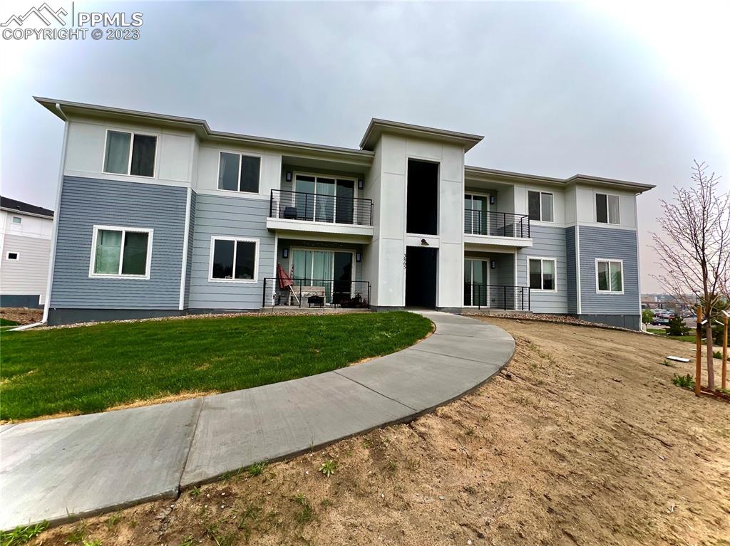 3865 Presidio Point, Unit 202 Colorado Springs, CO 80920 - Photo 28 of 30 a front view of a house with a yard