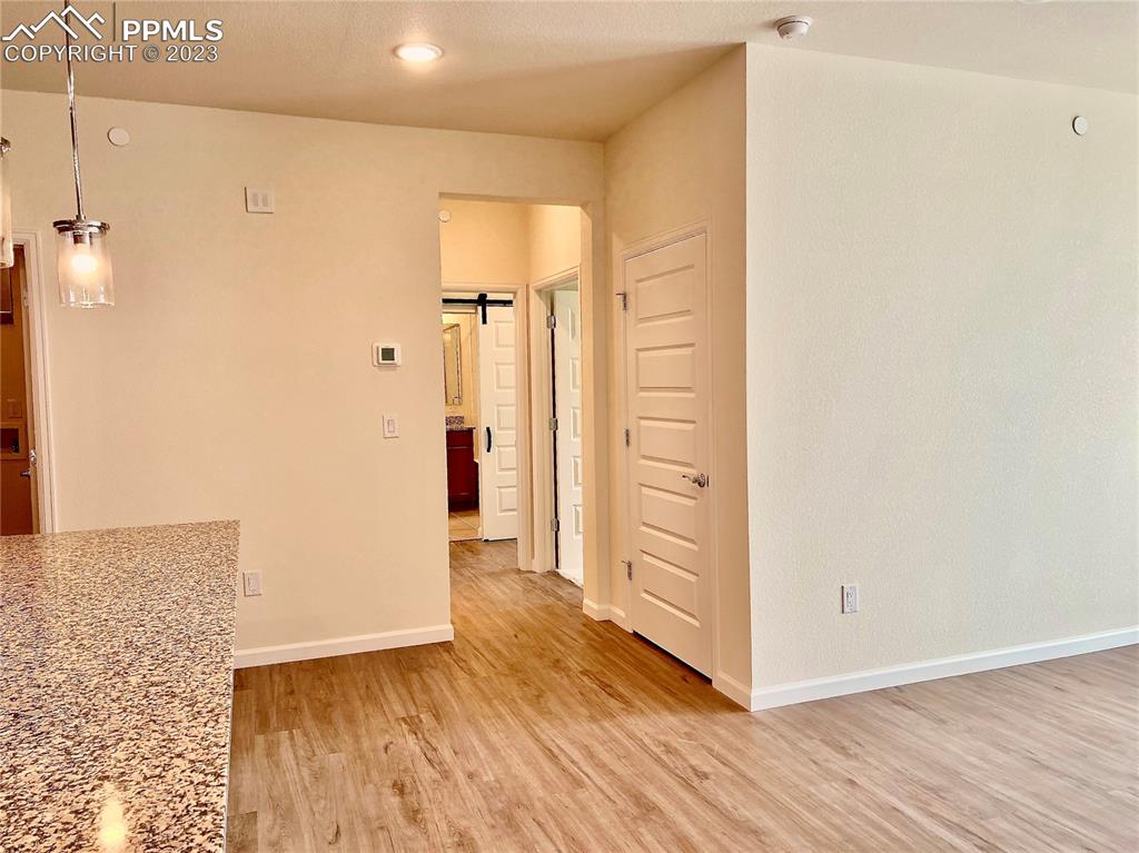 3865 Presidio Point, Unit 202 Colorado Springs, CO 80920 - Photo 8 of 30 a view of a hallway with wooden floor