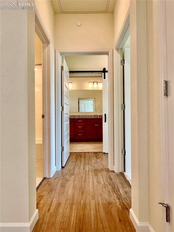 3865 Presidio Point, Unit 202 Colorado Springs, CO 80920 - Photo 9 of 30 a view of a hallway with wooden floor and a bathroom